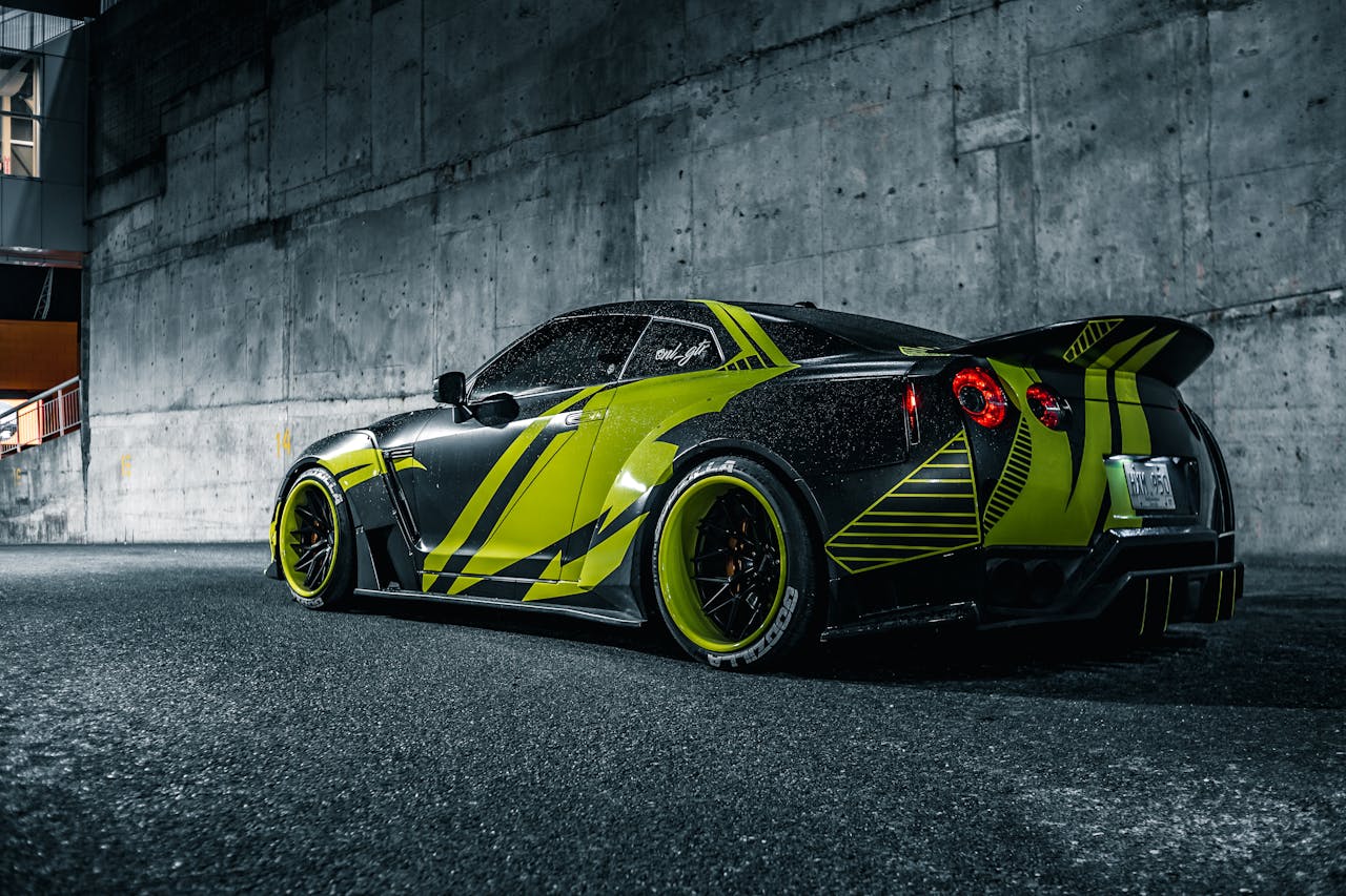 A luxury sports car with striking custom design parked in an urban location at night.